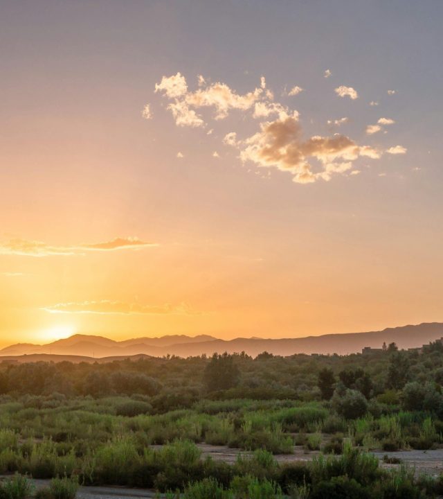 A breathtaking sunset over the lush countryside near Ouarzazate, Morocco, showcasing natural beauty.