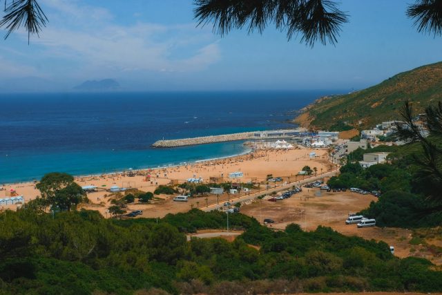 A breathtaking view of Tangier's vibrant beach and surrounding landscape under a clear blue sky.